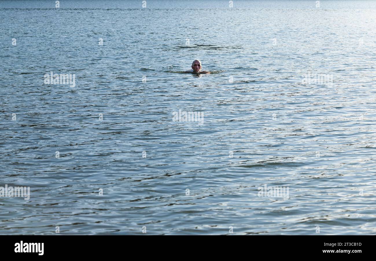 Man swimming in lake Stock Photo