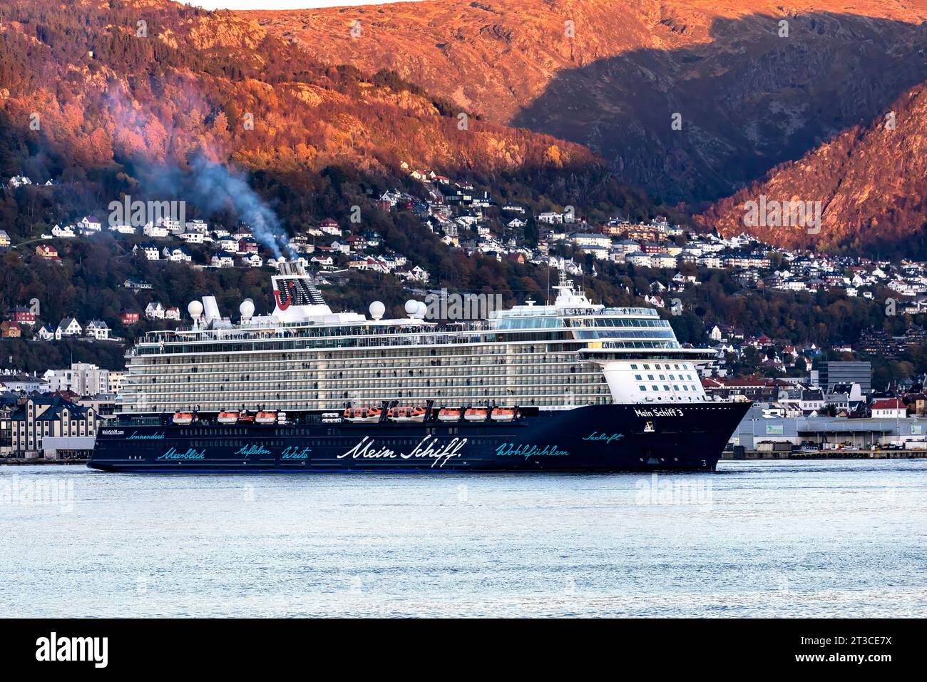 Cruise ship Mein Schiff 3 at Puddefjorden, departing late evening from the port of Bergen, Norway. Stock Photo