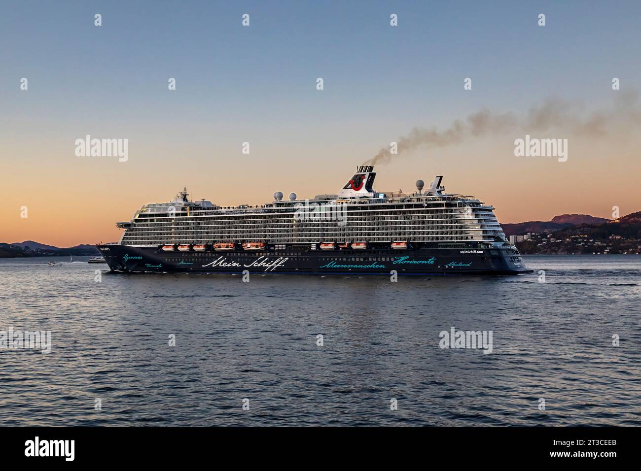 Cruise ship Mein Schiff 3 at Byfjorden, departing late evening from the port of Bergen, Norway. Stock Photo