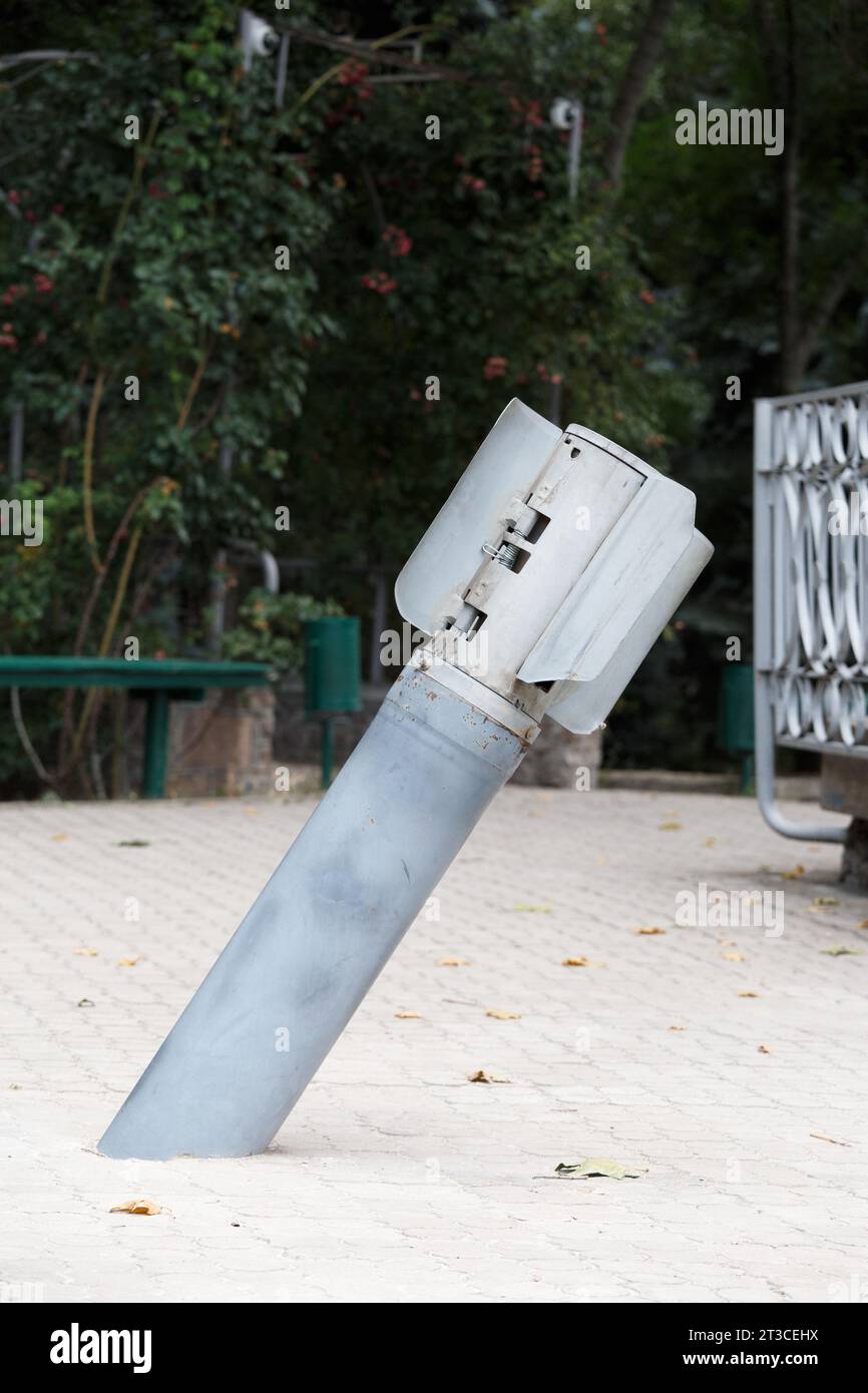 The tail of a cluster bomb sticks out of the pavement Multiple rocket launchers fired on the territory of Ukraine by Russian invaders, war in Ukraine Stock Photo
