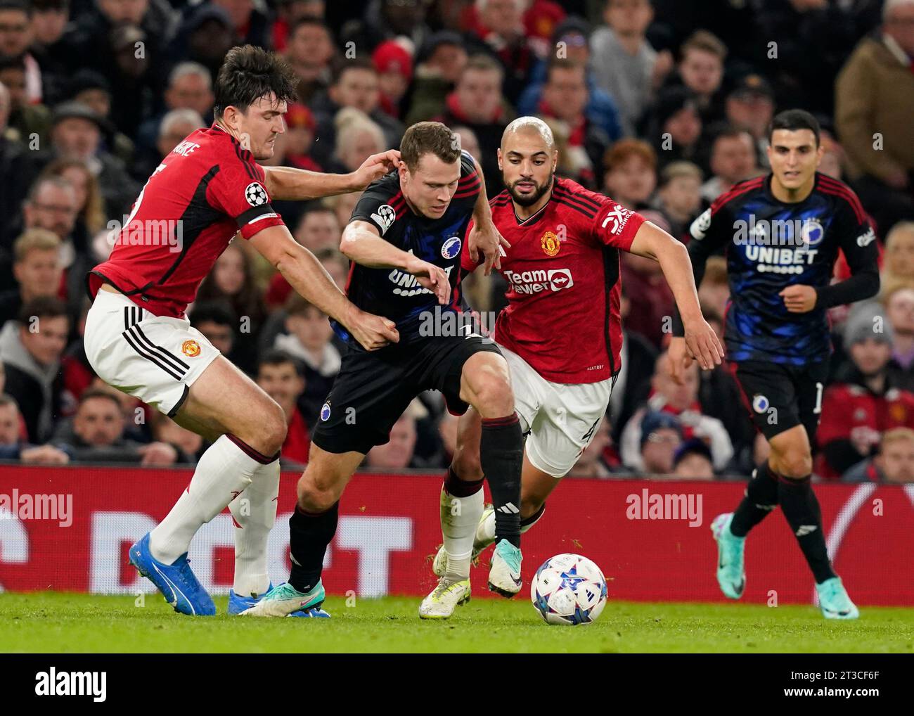 Manchester, UK. 24th Oct, 2023. Harry Maguire (l) and Sofyan Amrabat of Manchester United (r) tackle Viktor Claesson of FC Copenhagen during the UEFA Champions League match at Old Trafford, Manchester. Picture credit should read: Andrew Yates/Sportimage Credit: Sportimage Ltd/Alamy Live News Stock Photo
