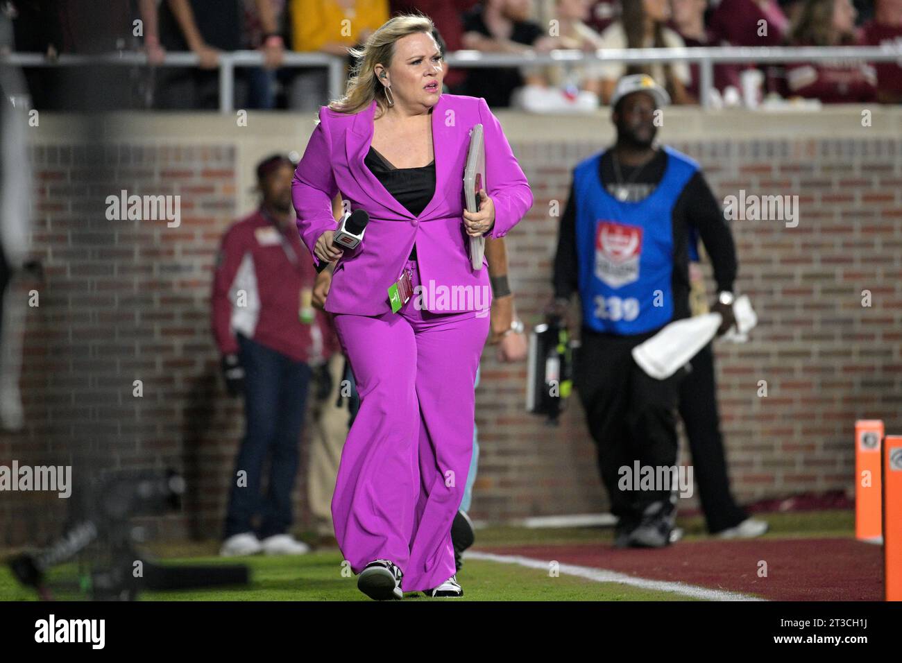 ESPN sideline reporter Holly Rowe walks behind the end zone during the