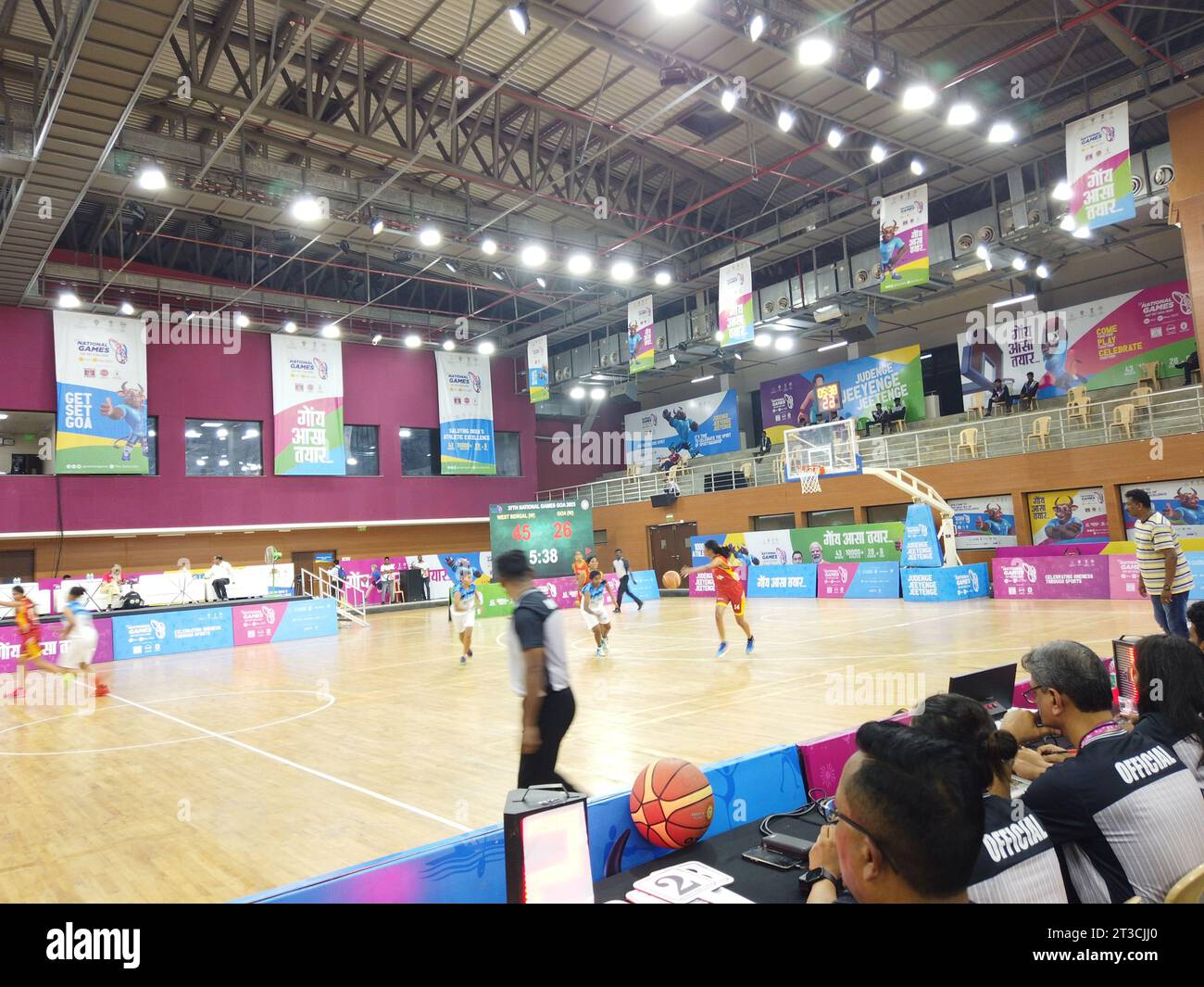 Action from the basketball match between hosts Goa and West Bengal of the National Games taking place at Manohar Parrikar Indoor stadium in Navelim village in the Indian state of Goa. The formal inauguration will take place on October 26 with Prime Minister Narendra Modi formally opening the championship at a function at Fatorda stadium. Stock Photo