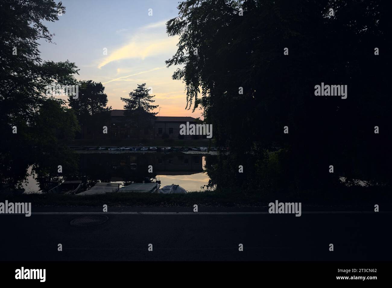 Sunset sky in a park and its reflection in the water Stock Photo - Alamy