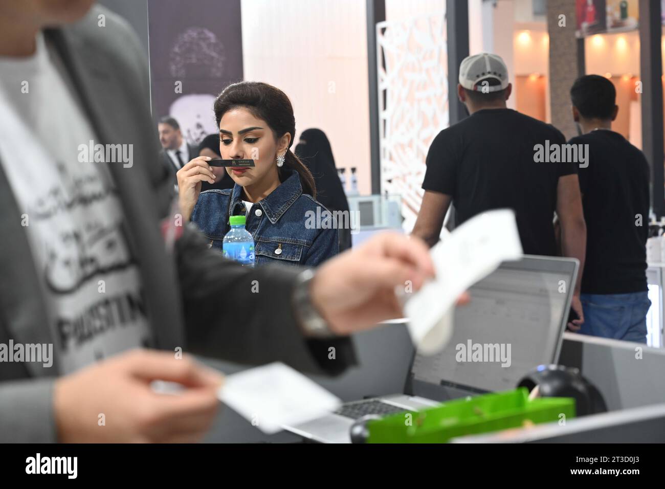 Hawalli, Kuwait. 24th Oct, 2023. A woman tries a perfume at a perfumes