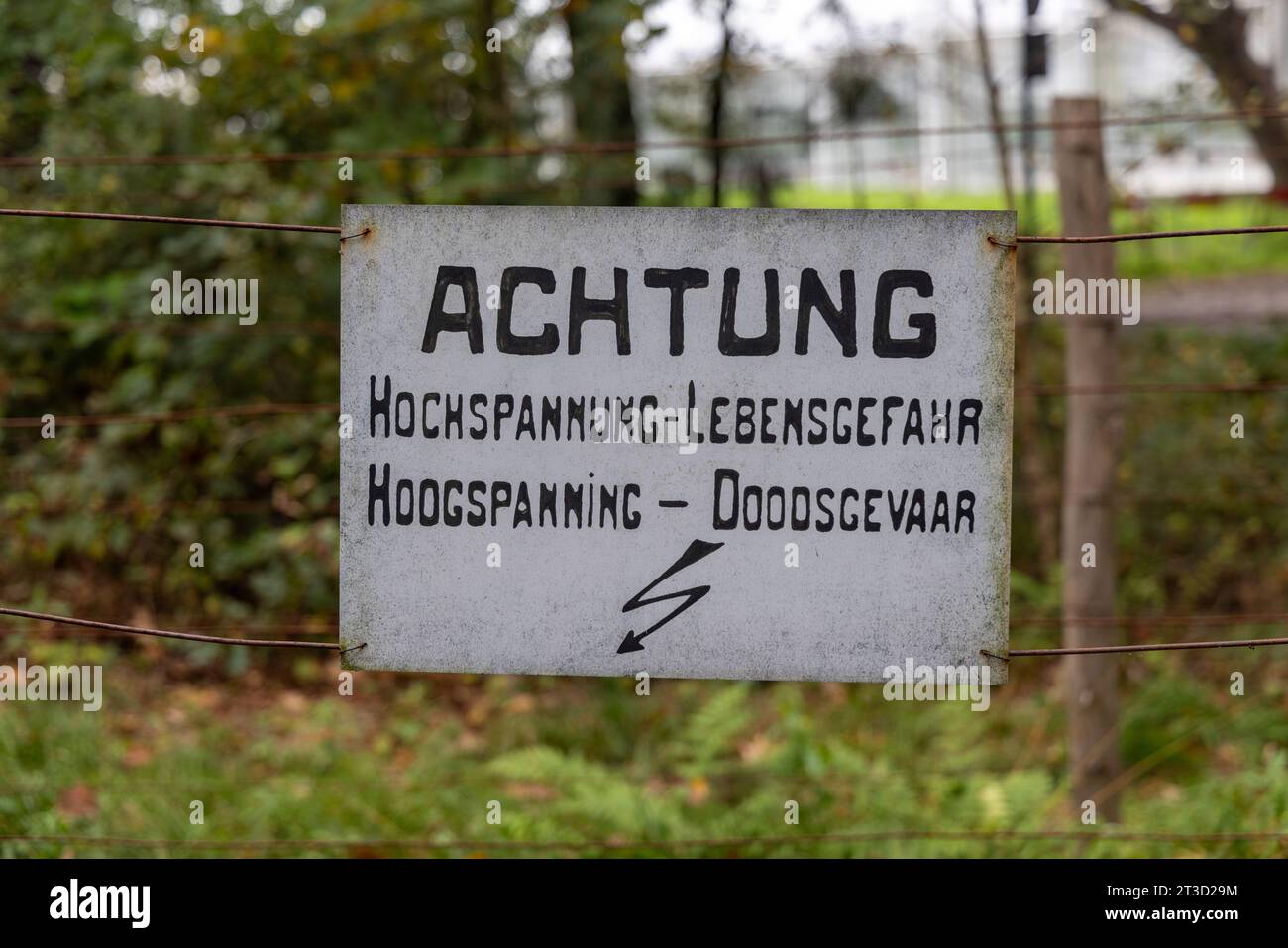 Sign at De Doodendraad near Hamont-Achel and Achelse Kluis, at border between Belgium & the Netherlands with text 'Achtung Hochspannung Lebensgefahr' Stock Photo