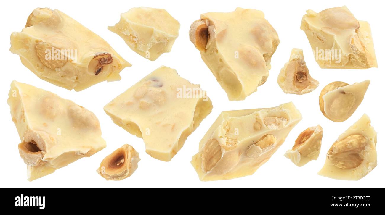 Broken white chocolate bar with hazelnuts isolated on white background Stock Photo