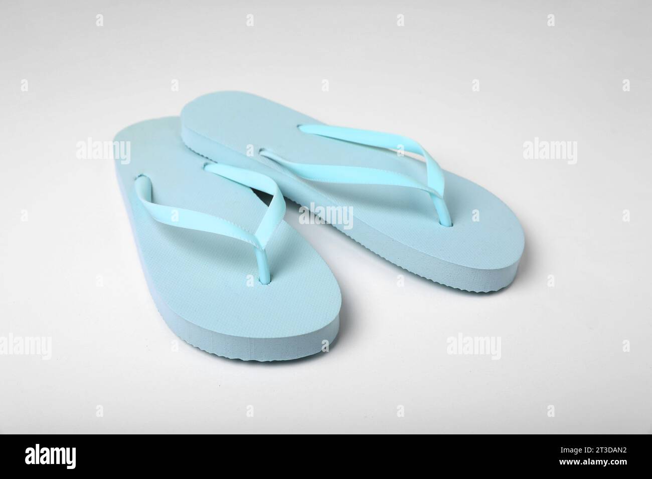Pair of stylish flip flops on white background Stock Photo - Alamy