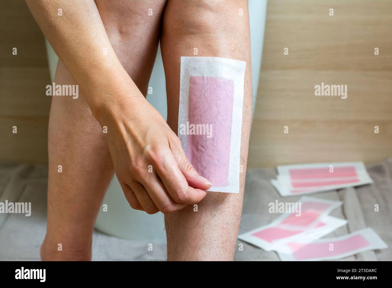 Leg hair removal with cold wax strips Stock Photo
