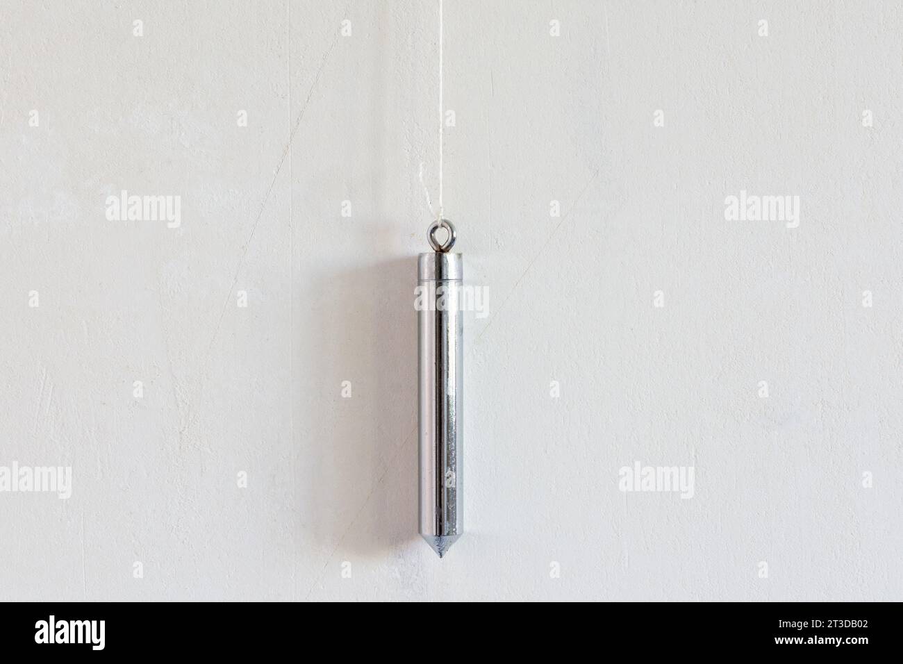 Installing wallpaper. Upholsterer's plumb line Stock Photo Alamy