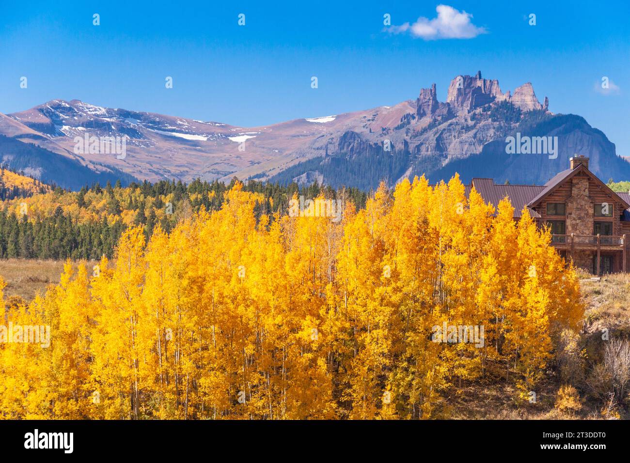 Ranching and farming in Colorado with autumn color with Aspens turning - in view of the Castles (mountains) along the Ohio Pass road. Stock Photo