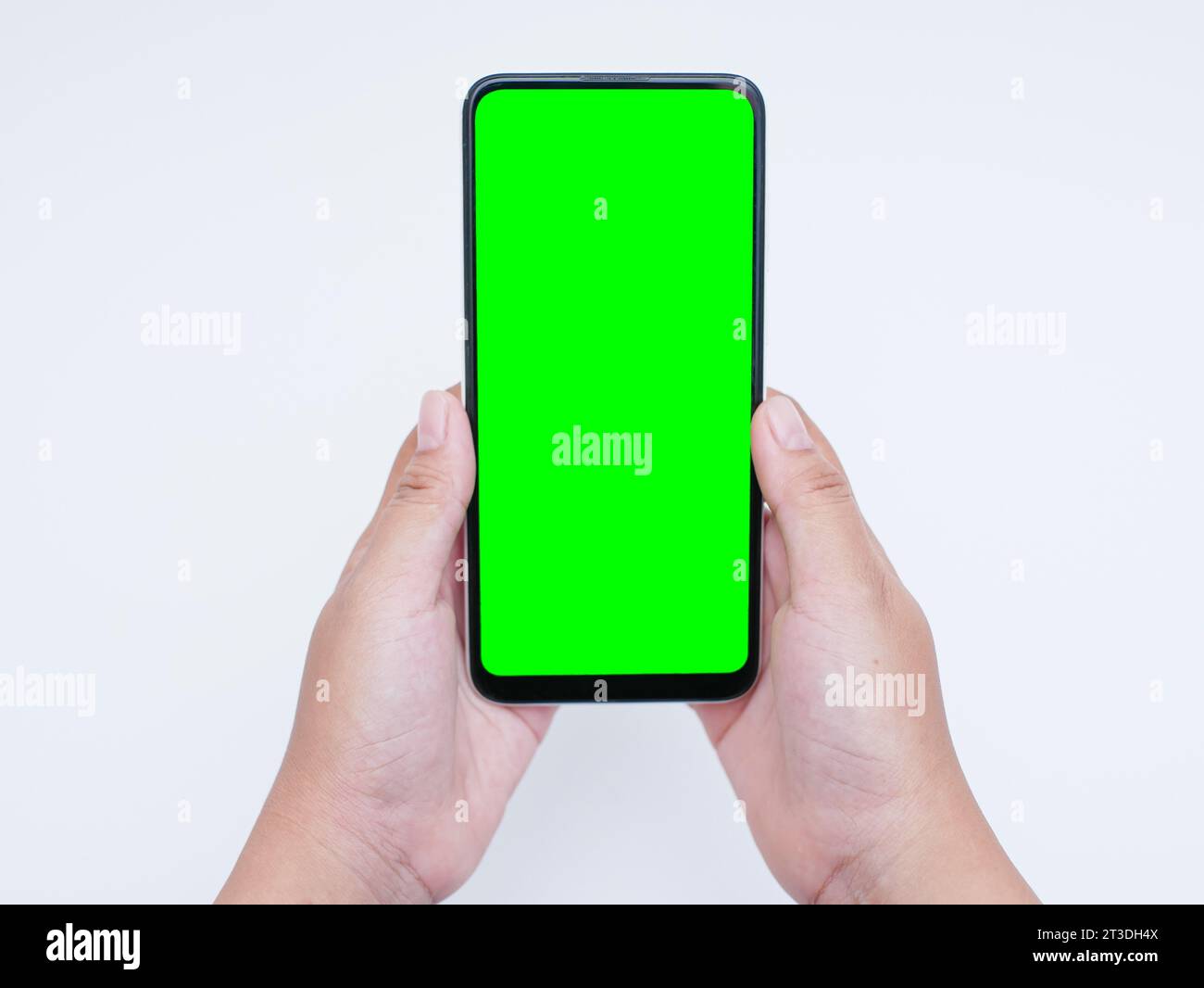 hand hold mobile smartphone with blank green screen isolated on white ...