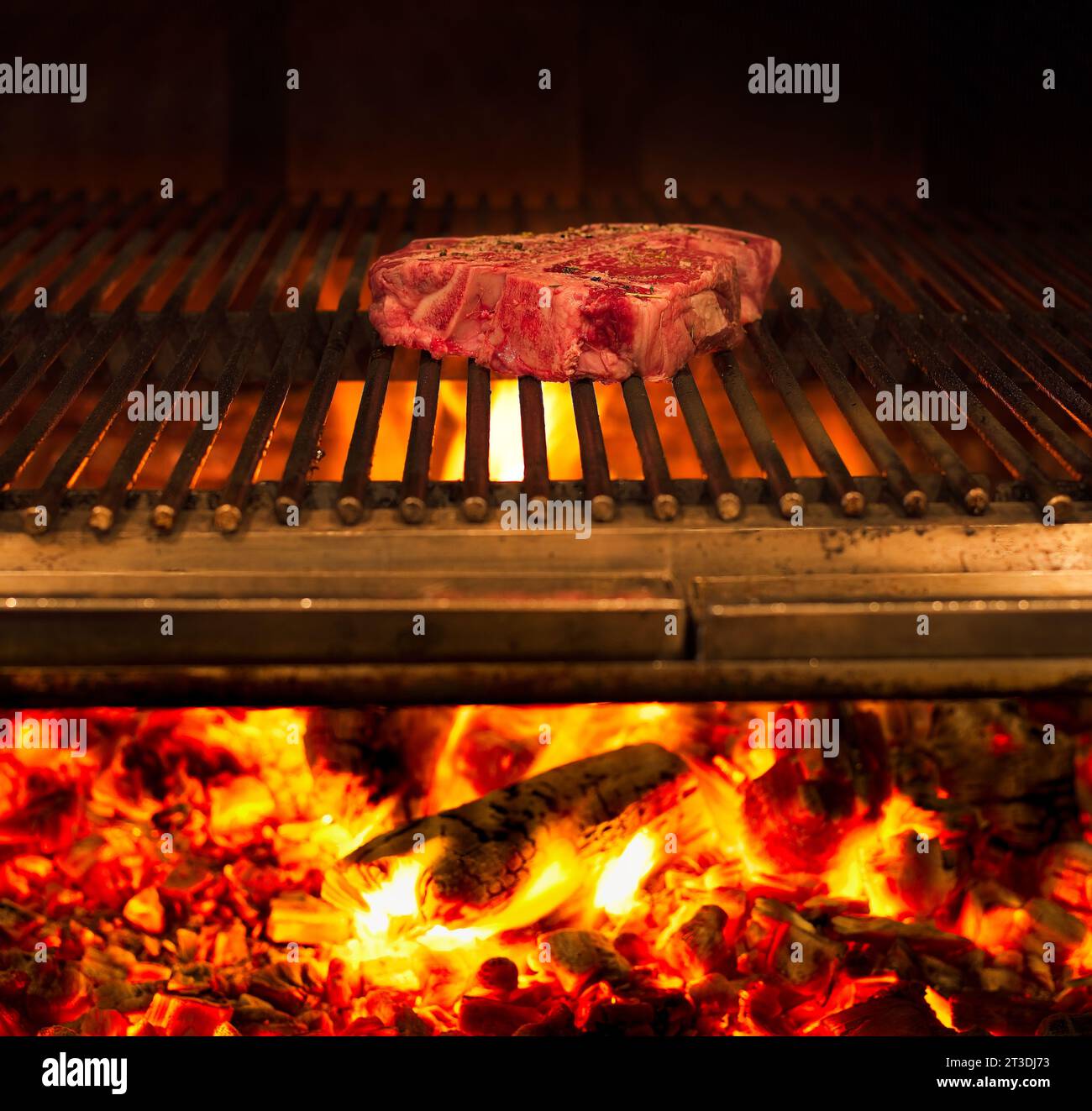 Grilled steak on broiler with flames Stock Photo Alamy