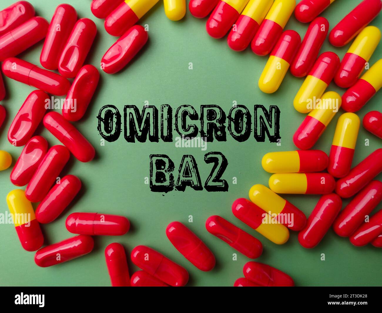 Top view medical pill with text OMICRON BA 2 on a green background. Stock Photo