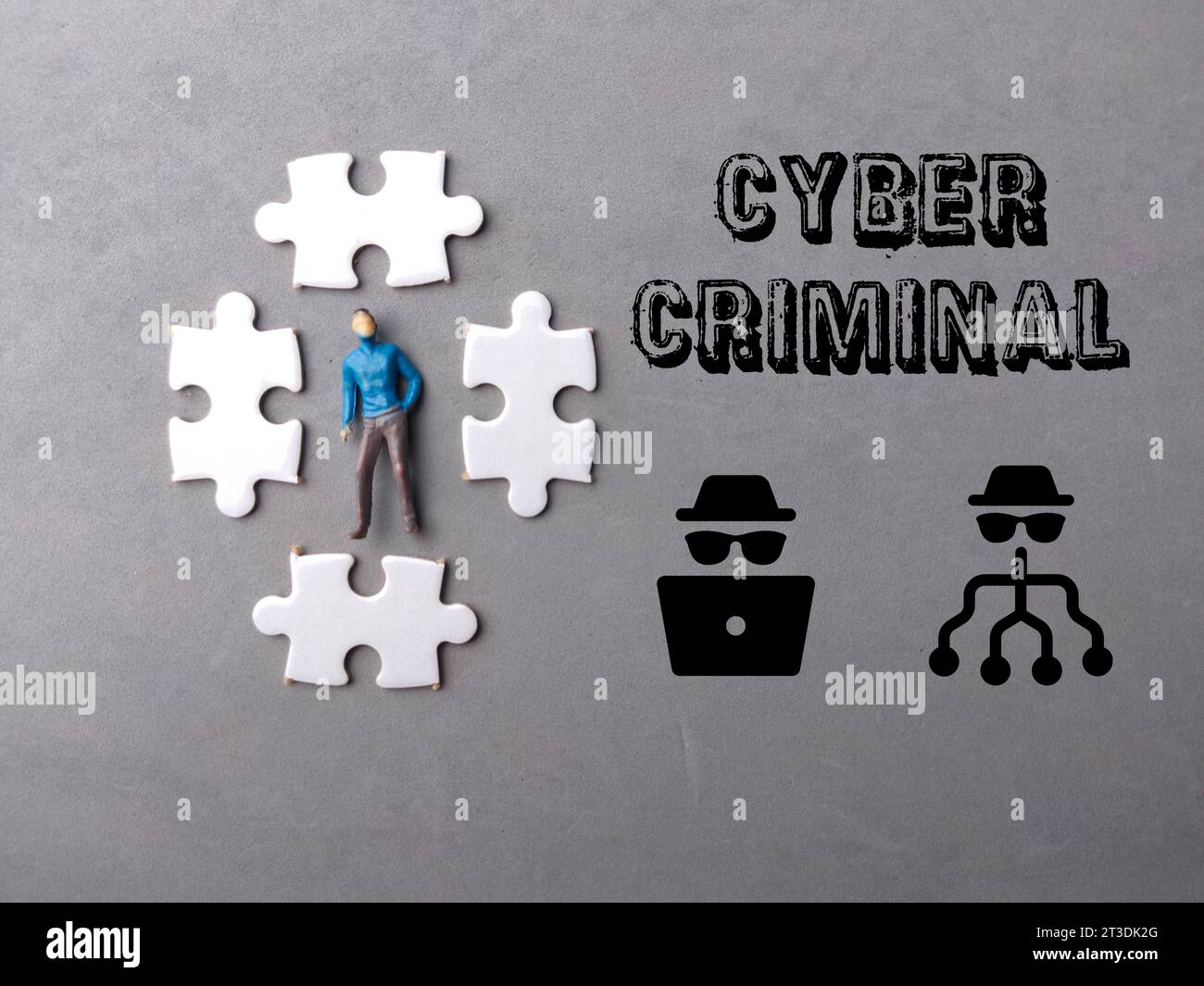 Top view miniature people and puzzle with text CYBER CRIMINAL on gray ...