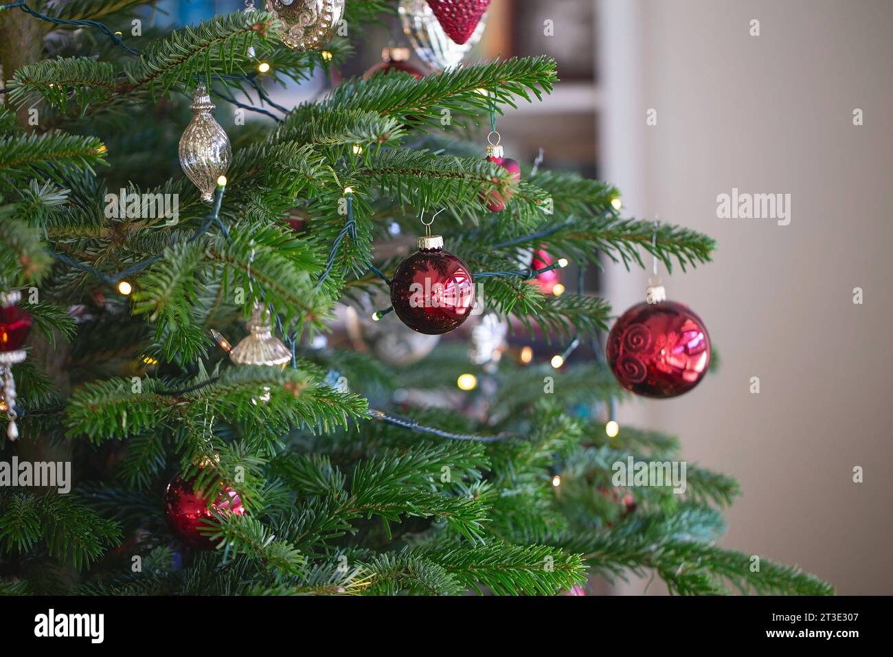 New year cozy home interior with Christmas tree and garlands. Christmas decoration in the house Stock Photo