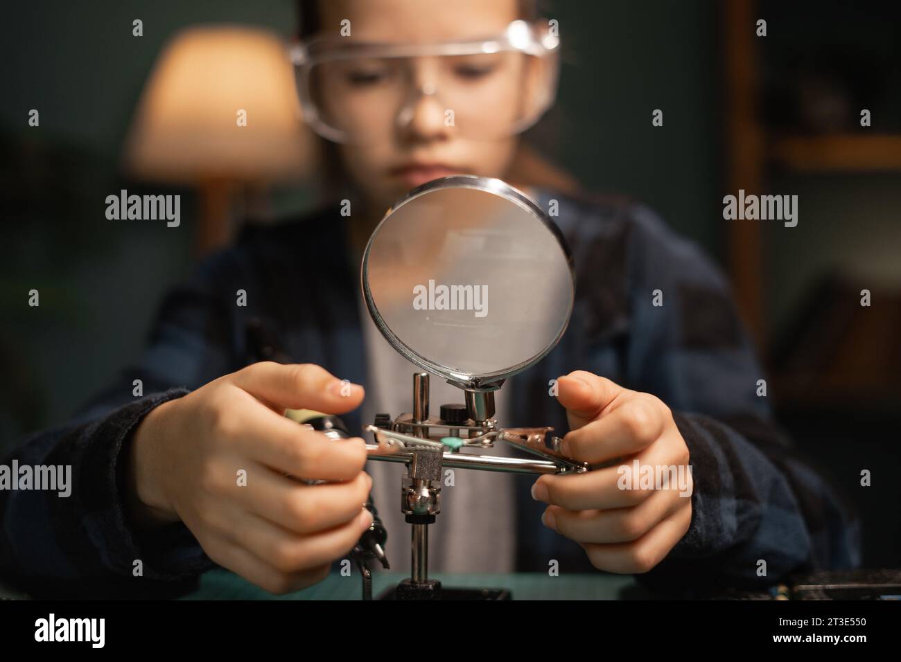 Teenager girl with safety glasses, future electronics technician