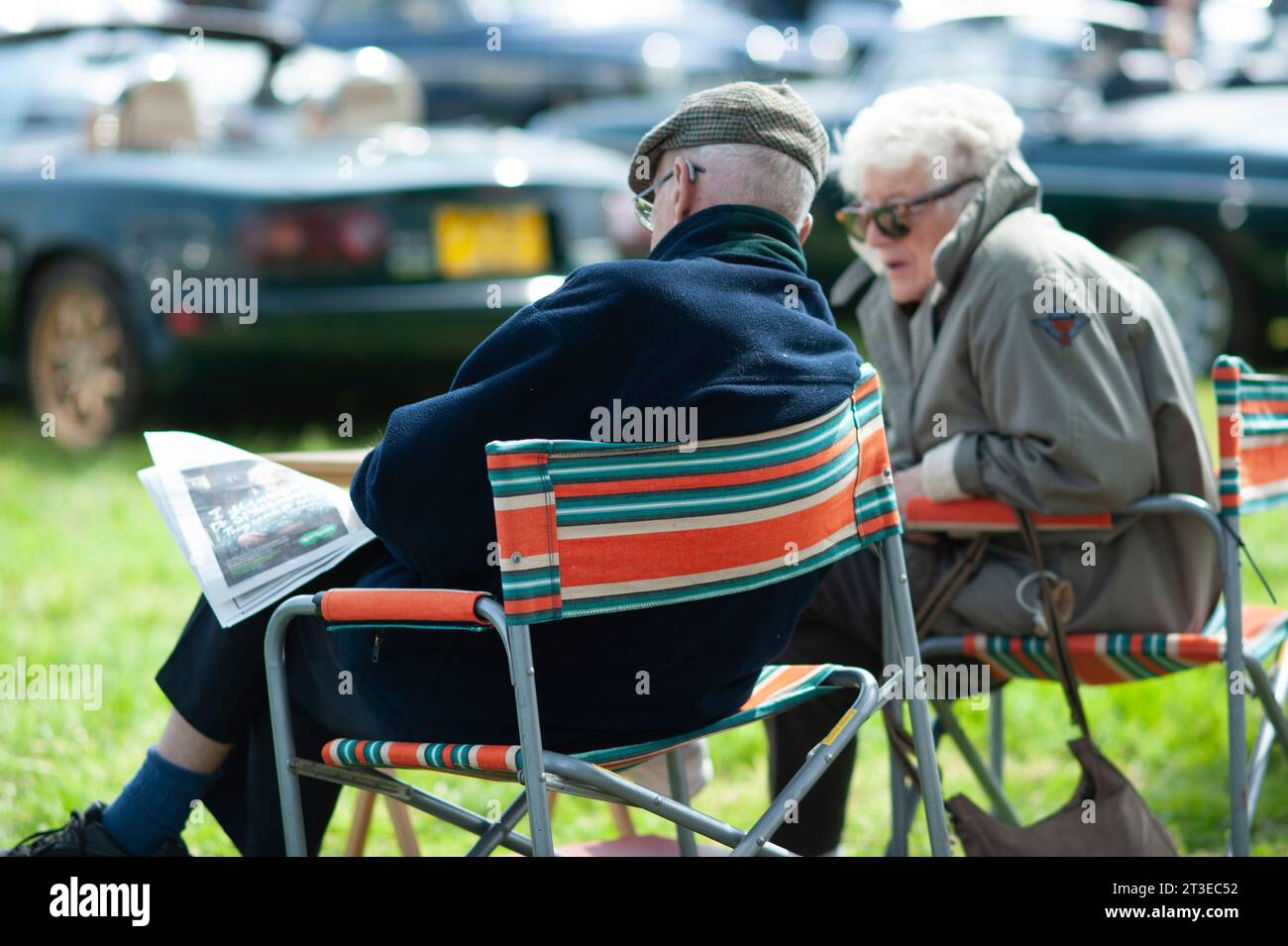 old couple sitting together outside earsham norfolk england Stock Photo