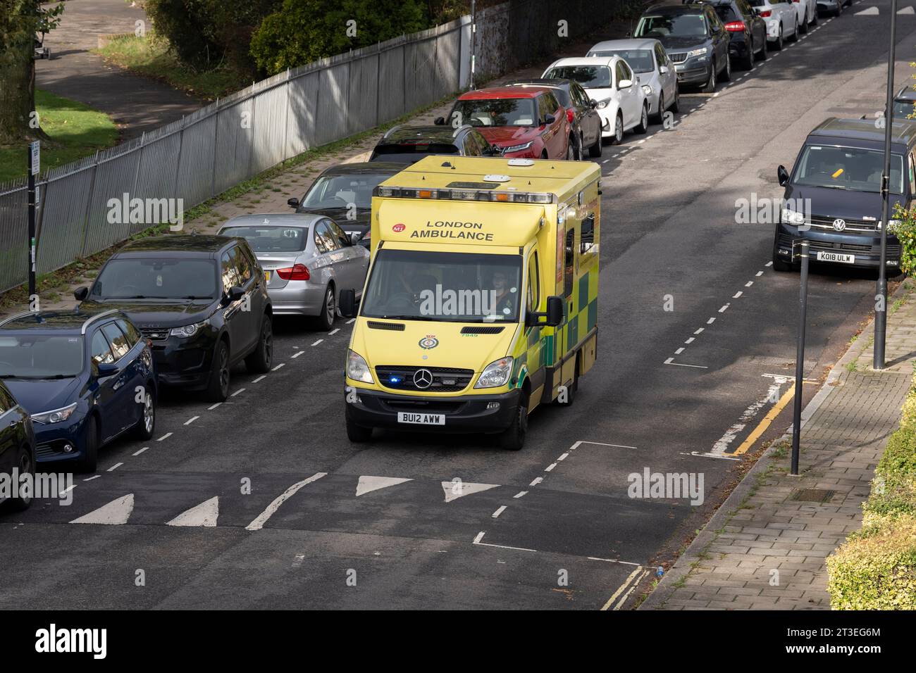 An NHS ambulance on an emergency call slows down for a speed hump while