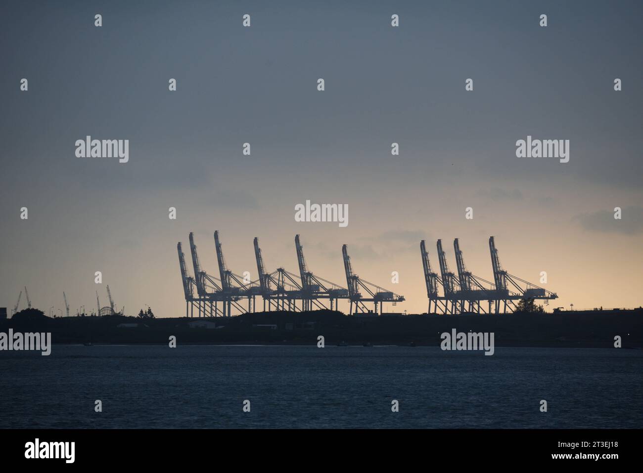 *** STRICTLY NO SALES TO FRENCH MEDIA OR PUBLISHERS - RIGHTS RESERVED ***October 03, 2023 - Tamsui, Taiwan: Silhouette of the cranes of the Port of Taipei, a strategic Taiwanese infrastructure located at the mouth of the Tamsui river. Stock Photo