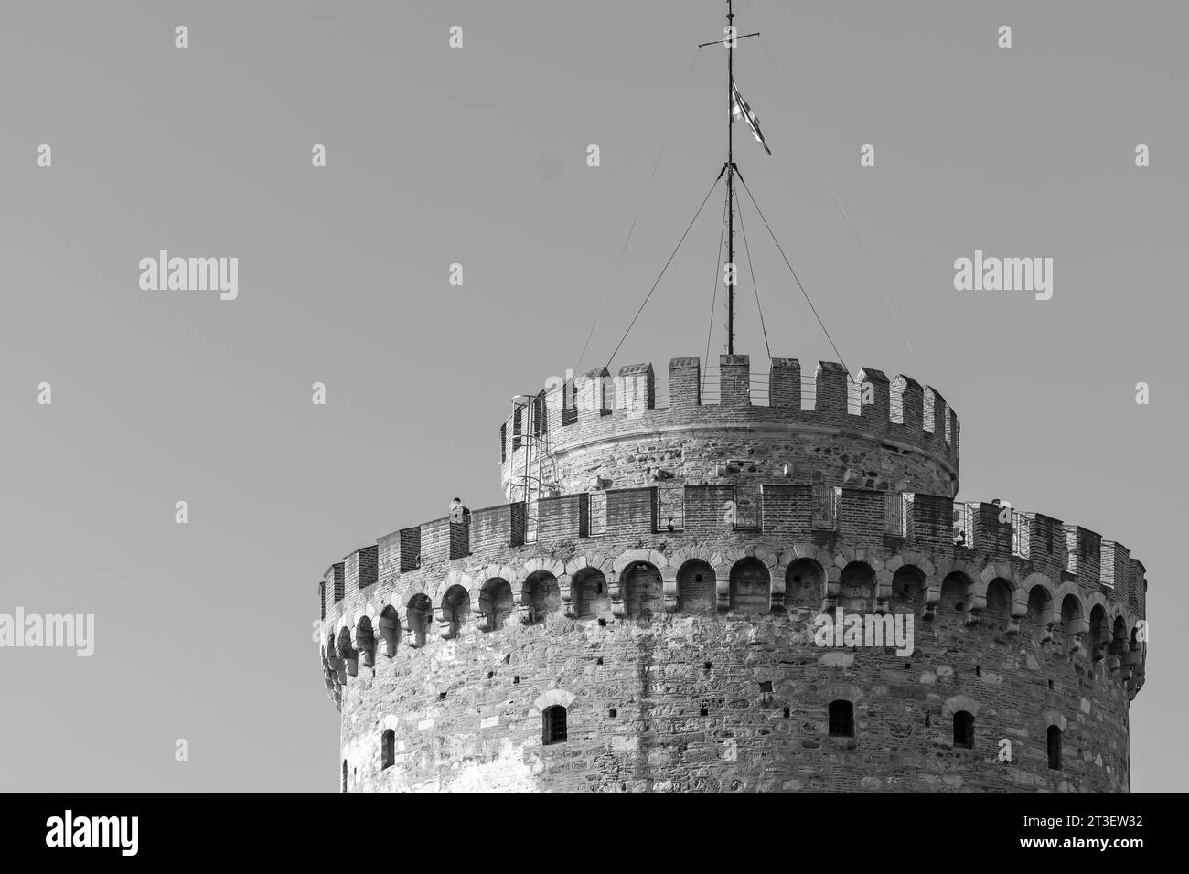 View of the White Tower, a monument and museum on the waterfront in Thessaloniki Greece in black and white Stock Photo