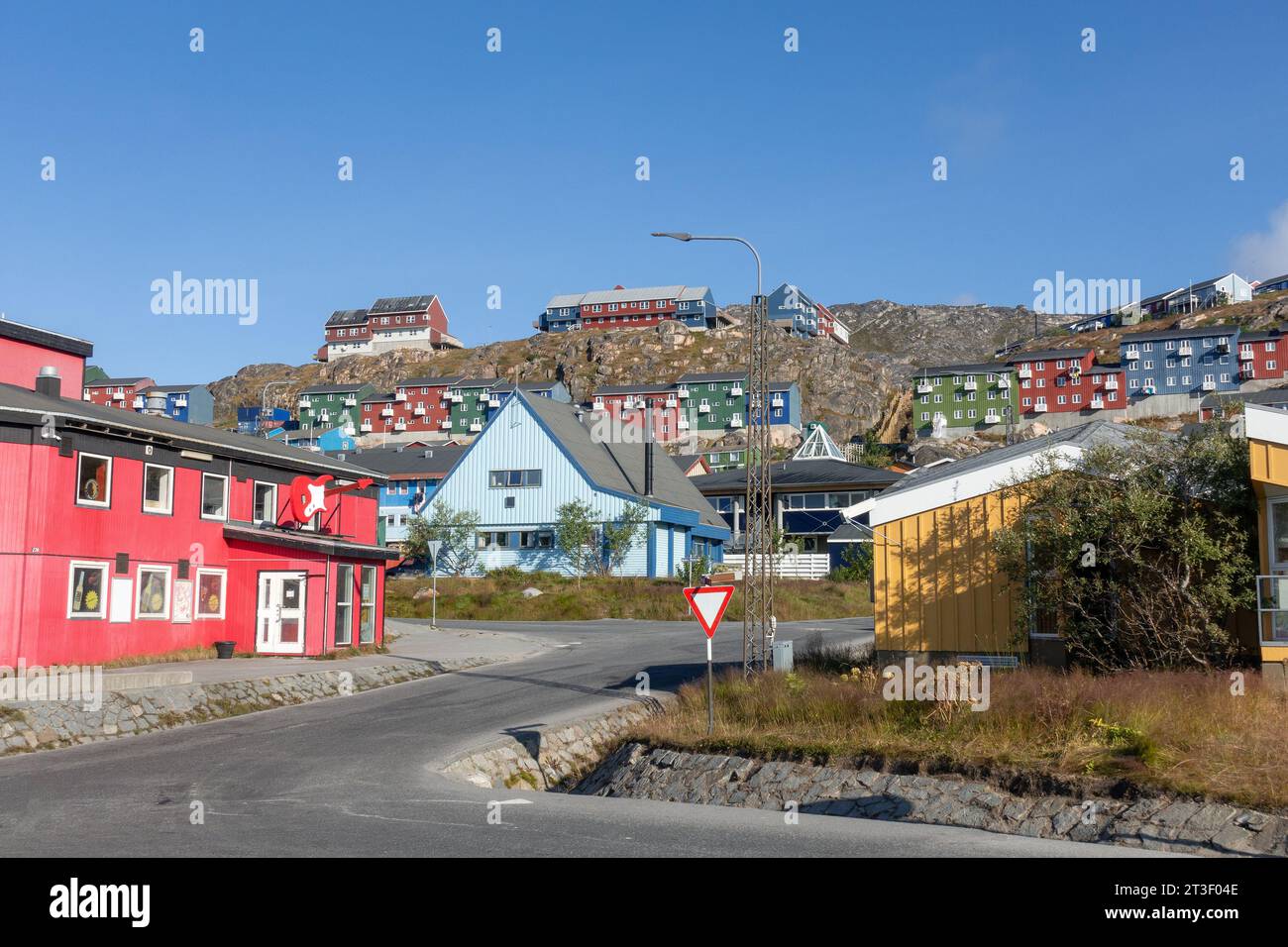 Traditional Colourful Greenland House On A Hill In The Town Of Qaqortoq Greenland, In The Early Morning Stock Photo