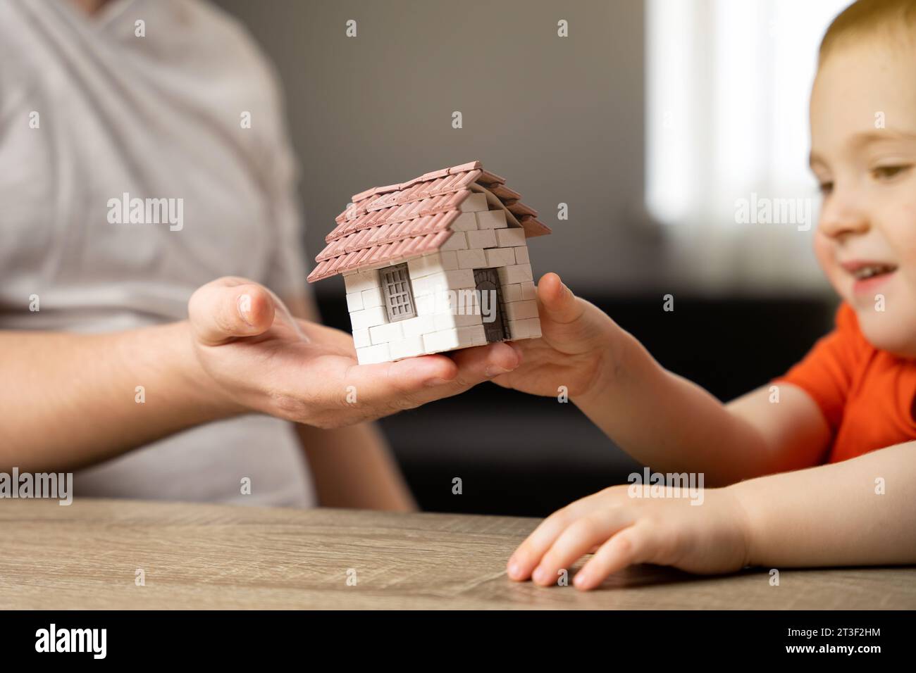A father gives his son a small house. The concept of transfer of