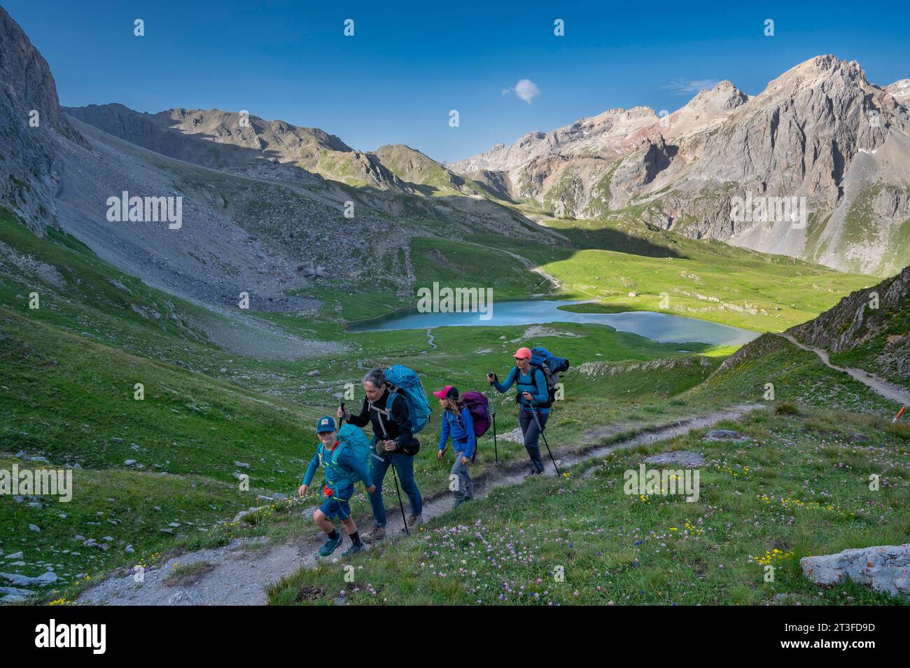 France, Savoie, Cerces massif, Valloires, hike towards the Col des Rochilles, family of hikers towards the Lac des Cerces and the Pointe des Cerces Stock Photo