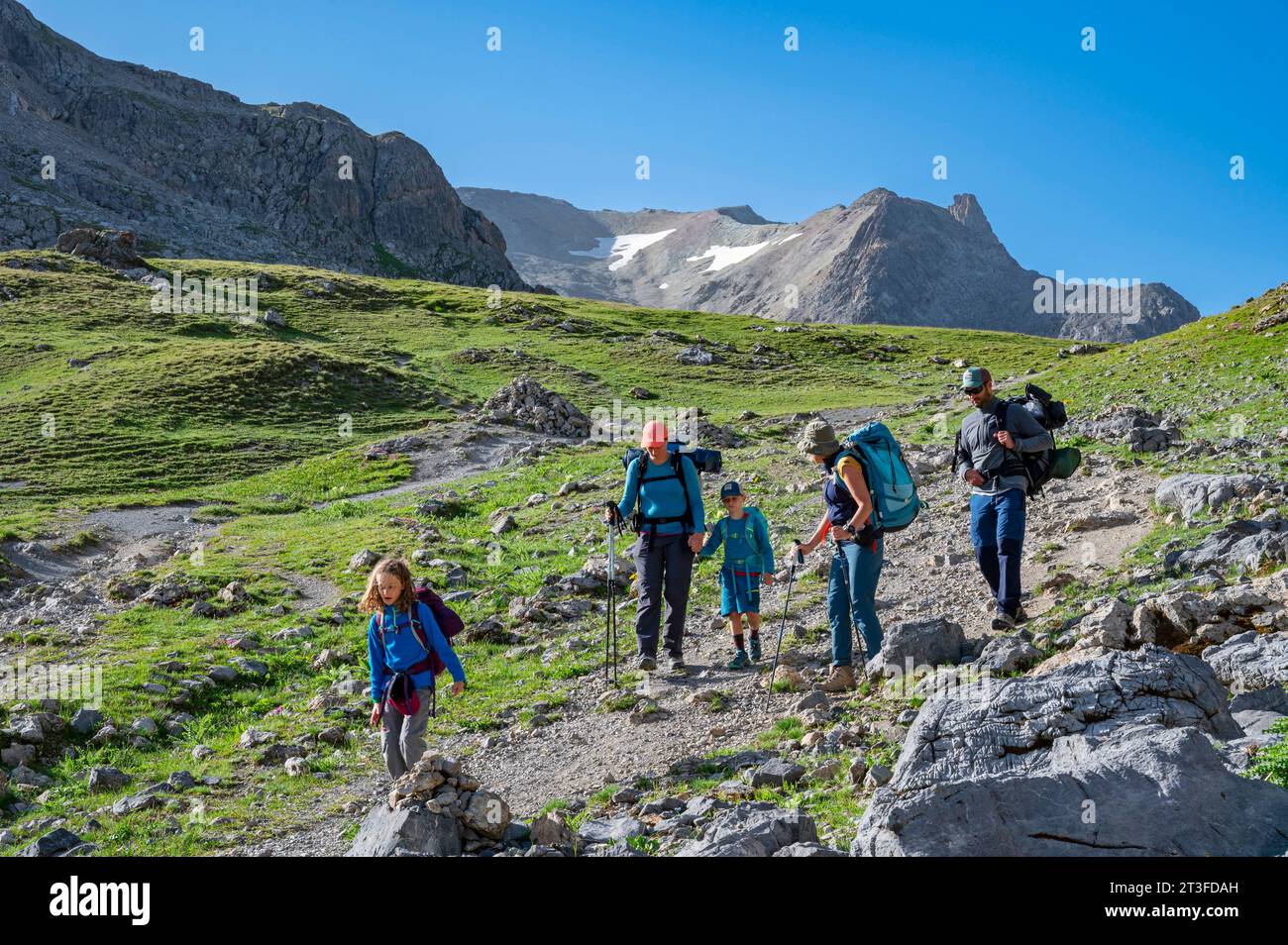 France, Savoie, Cerces massif, Valloires, hike towards the Col des Rochilles, family of hikers passing the Col des Cerces and the Pointe des Cerces Stock Photo