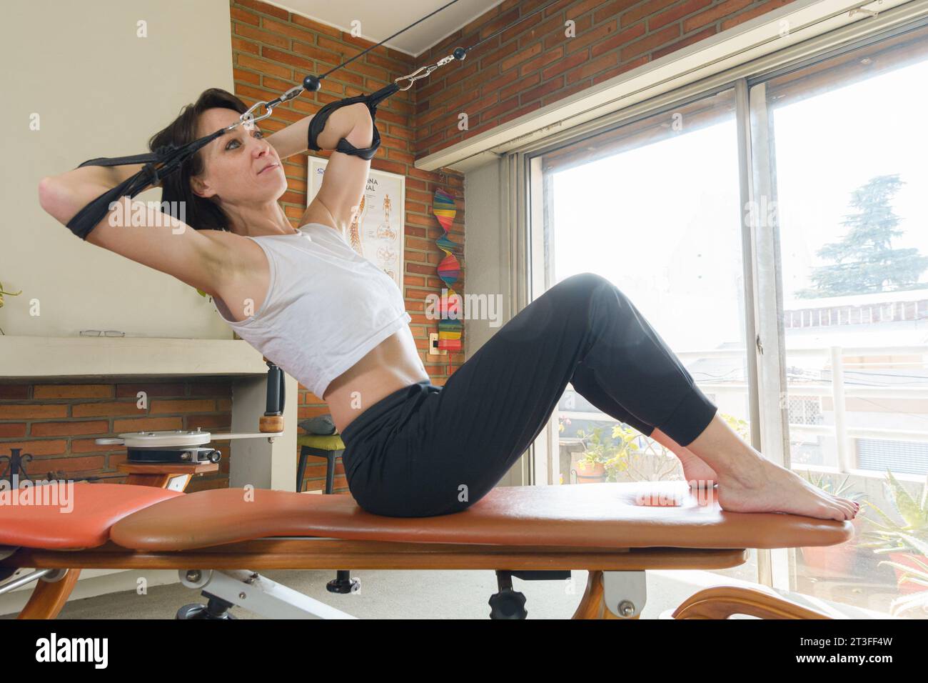 adult woman at home doing abdominal exercise and strengthening back
