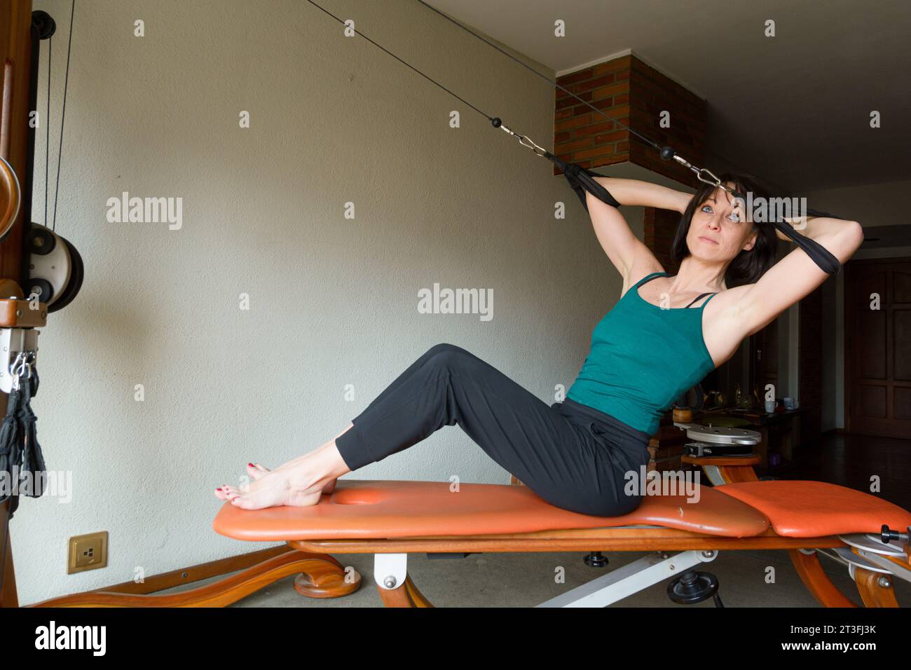 Latin adult woman at home training balance and energy, strengthening ...