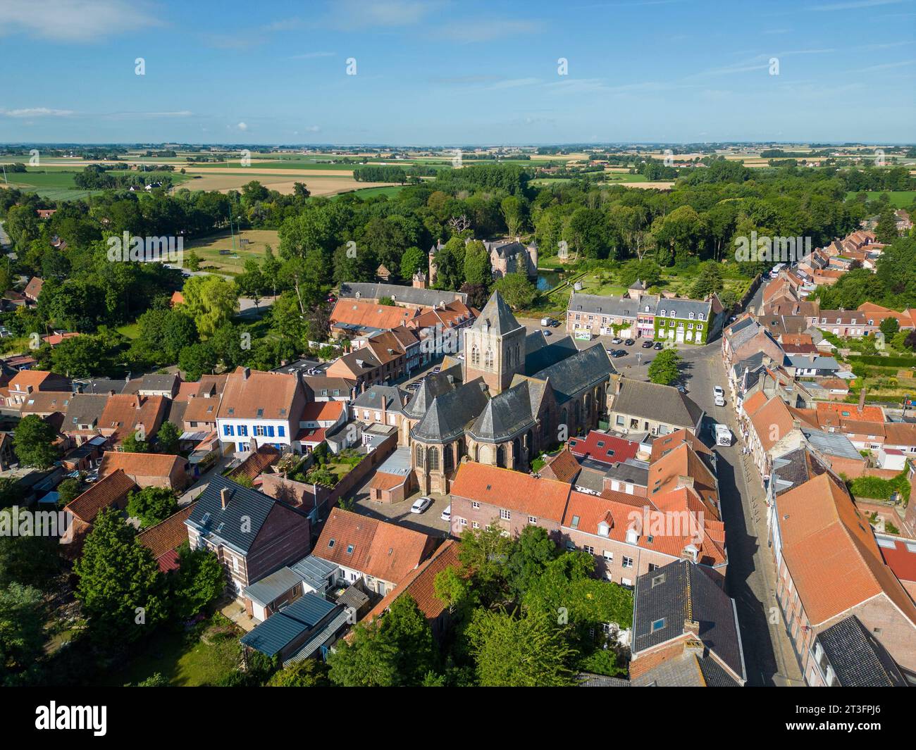 France, Nord, Esquelbecq, favorite village of the French 2023, Saint Folquin church and castle of Esquelbecq (aerial view) Stock Photo
