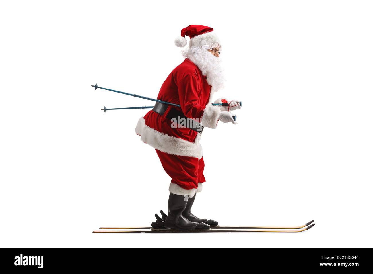 Full length profile shot of Santa Claus skiing isolated on white background Stock Photo