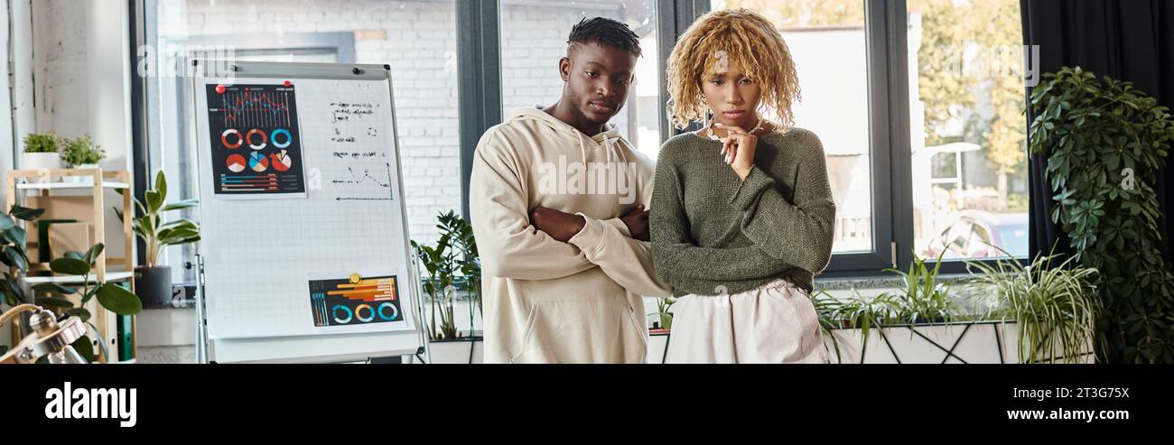 thoughtful african american friends in casual outfits working together, business concept, banner Stock Photo