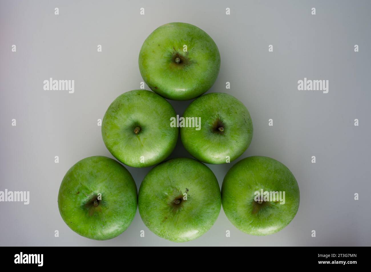 Pyramid of green apples frome the top. Organic fresh fruits and image of fall harvest background Stock Photo