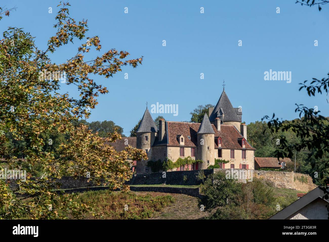 A  French Chateau, perched on the hill in the countryside of Creuse with a blue sky background. Stock Photo