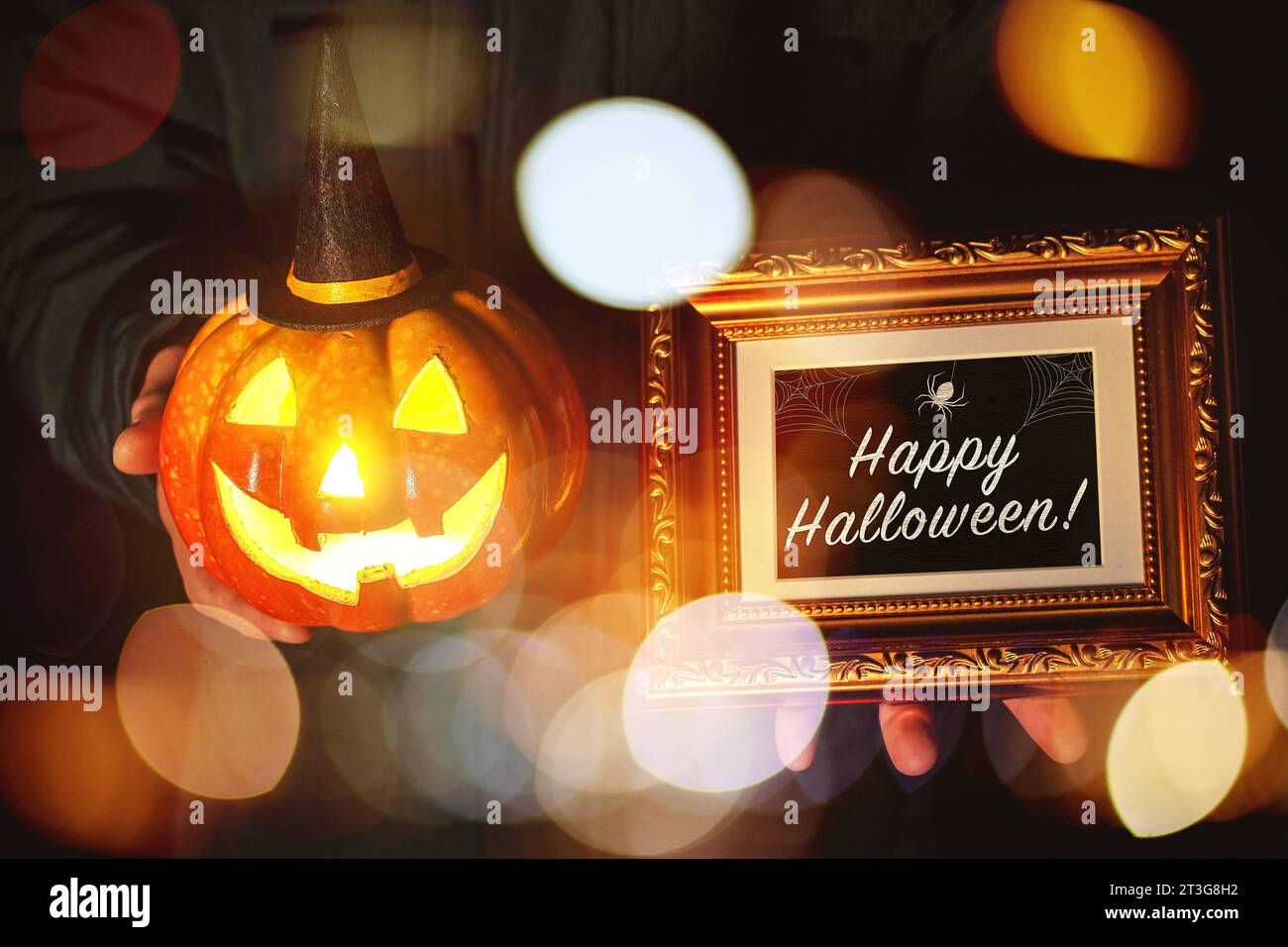 25 October 2023: Happy Halloween greeting on a golden plaque held by a man holding a glowing Halloween pumpkin with witch hat at night PHOTOMONTAGE *** Happy Halloween Gruß auf einer goldenen Tafel von einem Mann in der Hand gehalten der einen leuchtenden Halloween Kürbis mit Hexenhut bei Nacht hält FOTOMONTAGE Credit: Imago/Alamy Live News Stock Photo