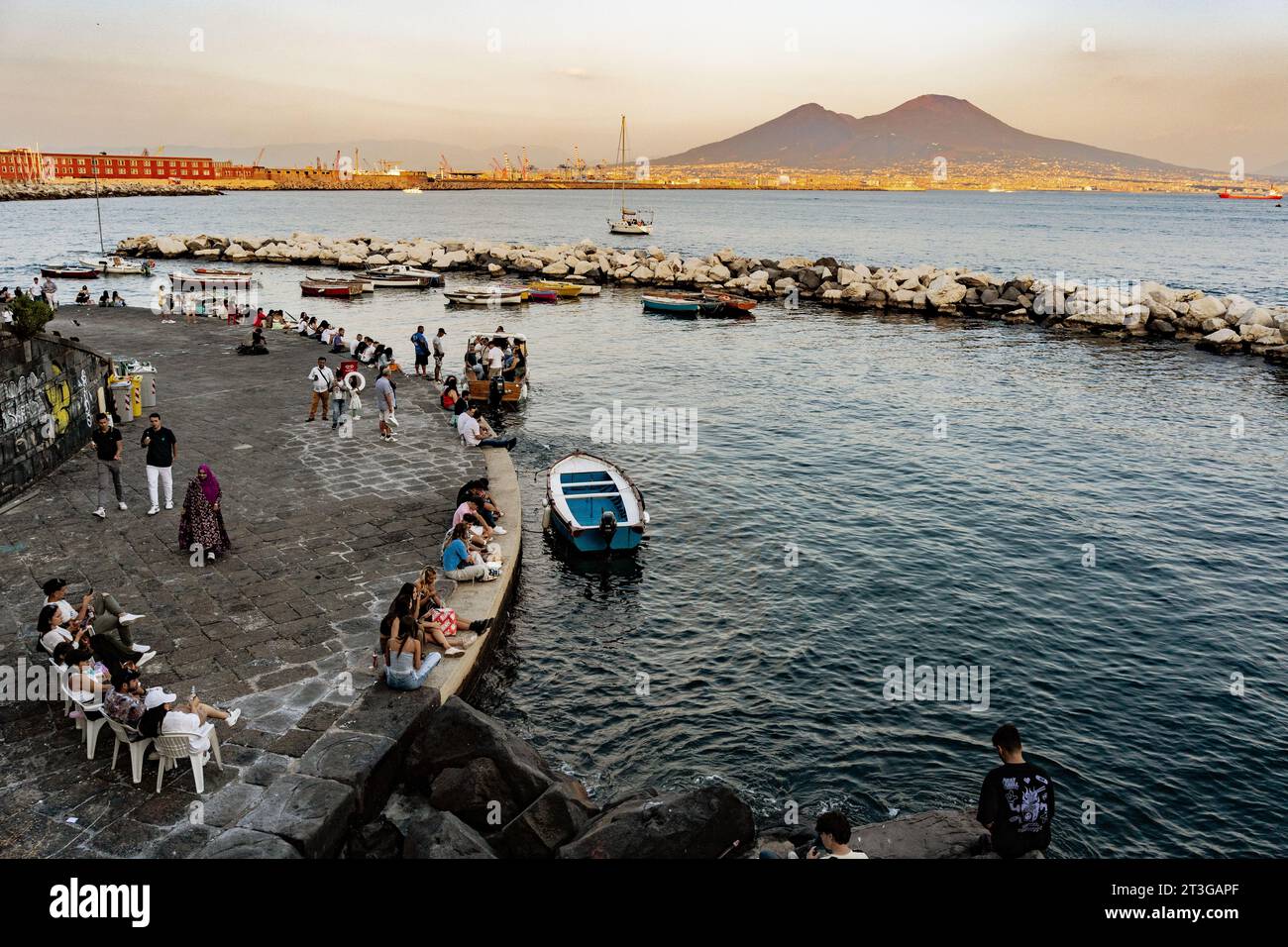 Naples, Italy - October 1, 2023: Vesuvius seen and fish boats from the seafront of Naples, Italy Stock Photo