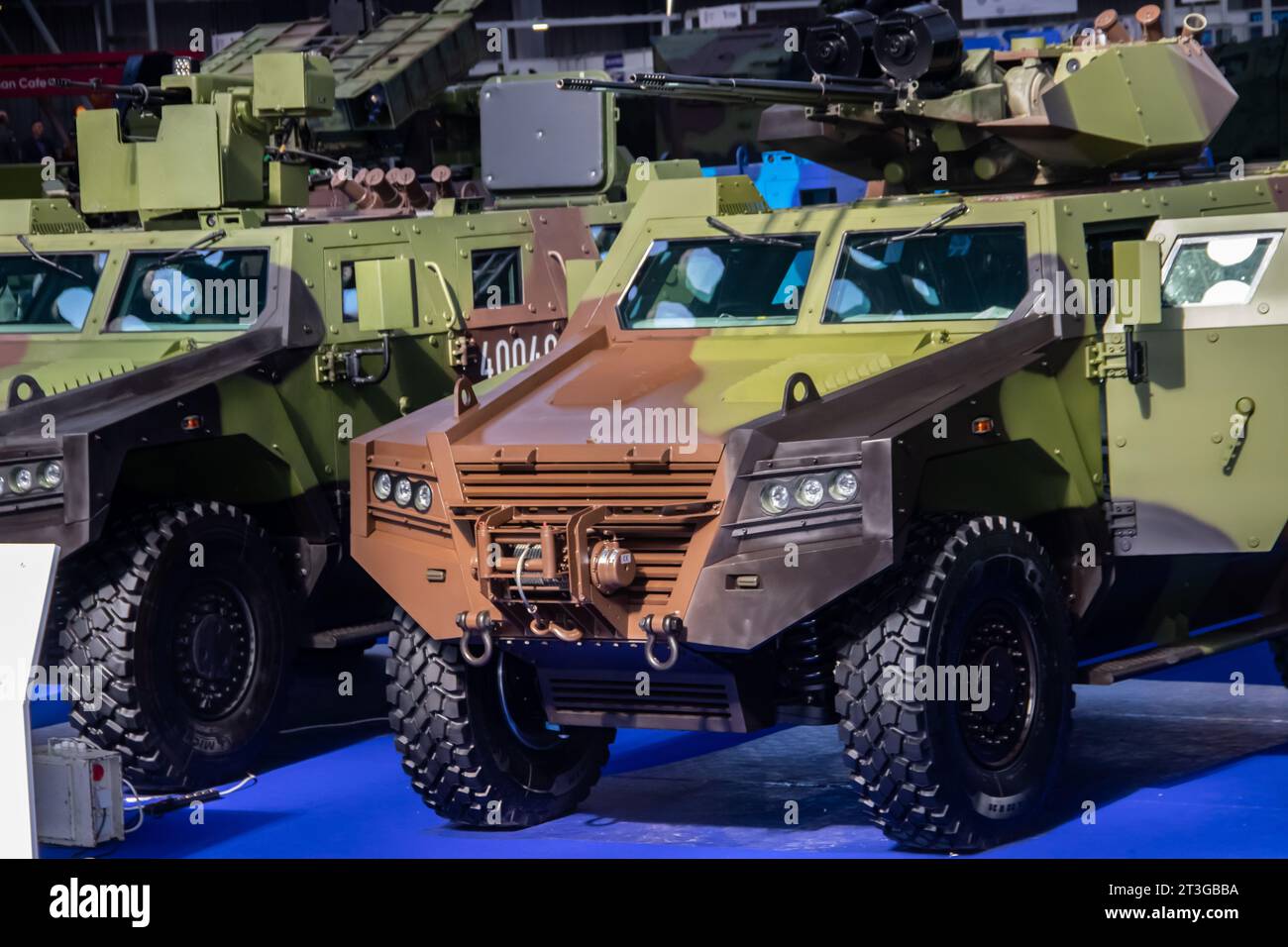 Armored combat vehicle painted in camouflage colors, armed with lethal machine gun and rocket launcher, at the international arms fair in Belgrade Stock Photo