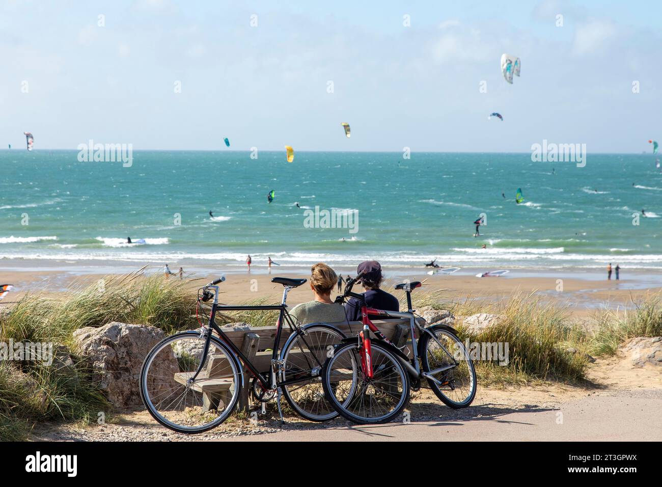 France, Pas de Calais, Wissant, couple watching kitesurfing on the water Stock Photo