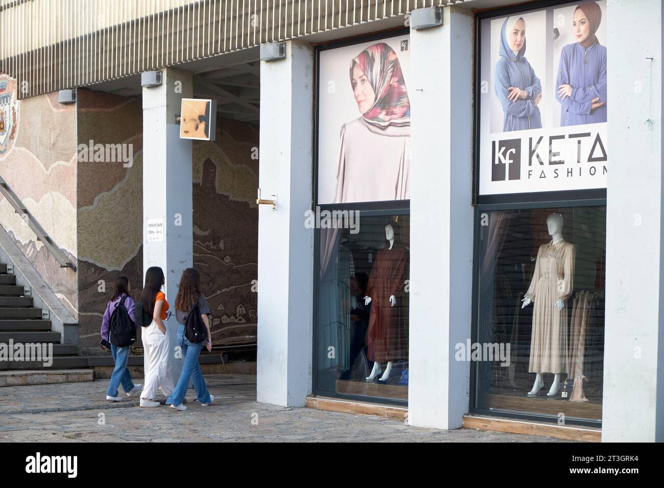 North Macedonia, Skopje, young women walking into a clothing store