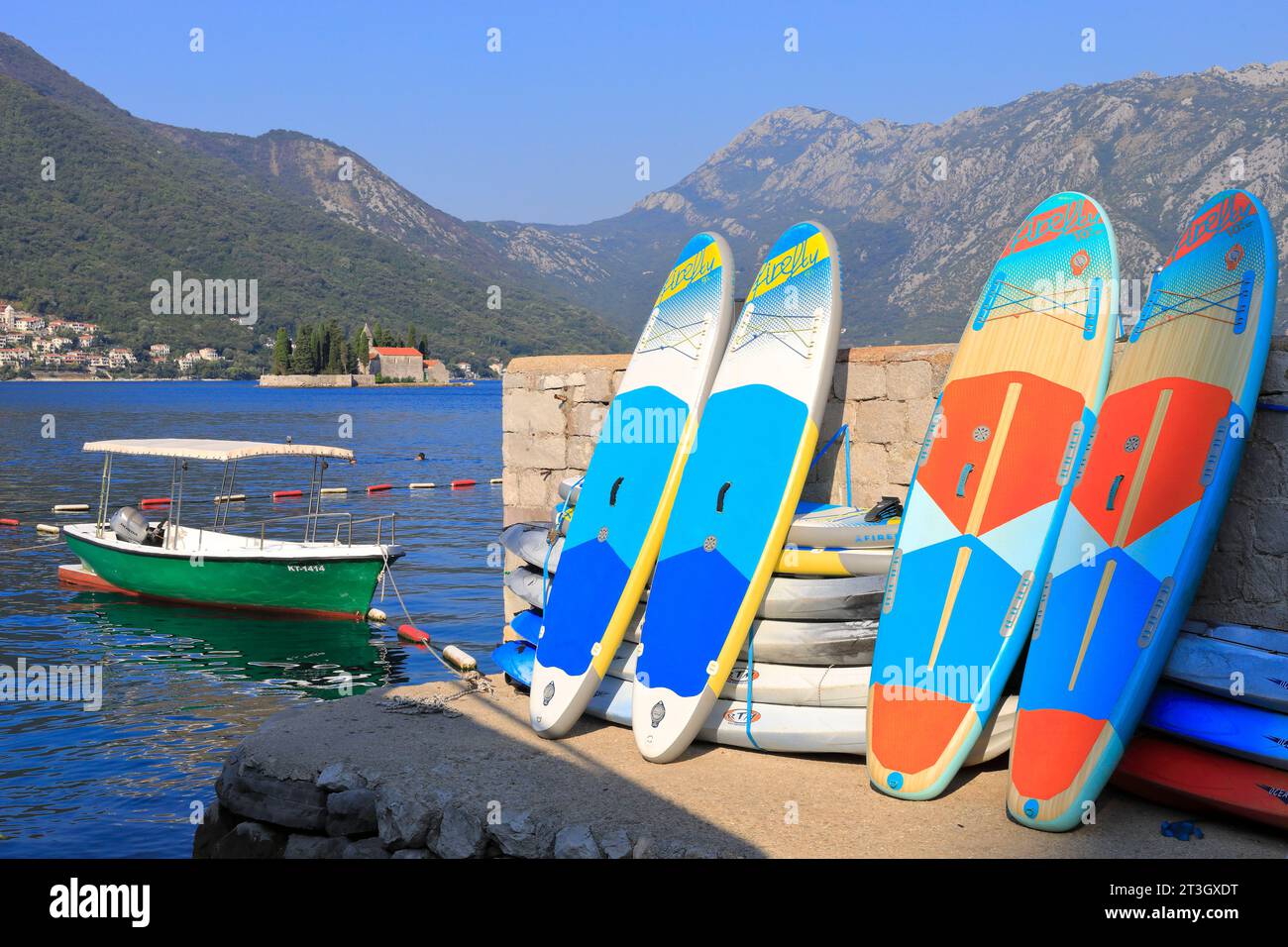 Montenegro, Bay of Kotor listed as World Heritage by UNESCO, Perast (municipality of Kotor) with the islet Sveti Djordje in the background, windsurfing boards Stock Photo