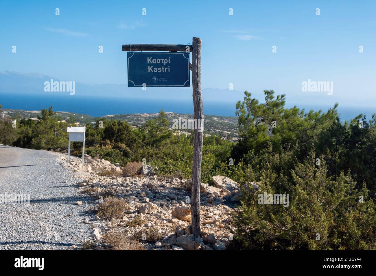 Metal hanging old sign with Kastri logo on wooden pole at Gavdos island, Crete Greece. Information label about village name background. Stock Photo