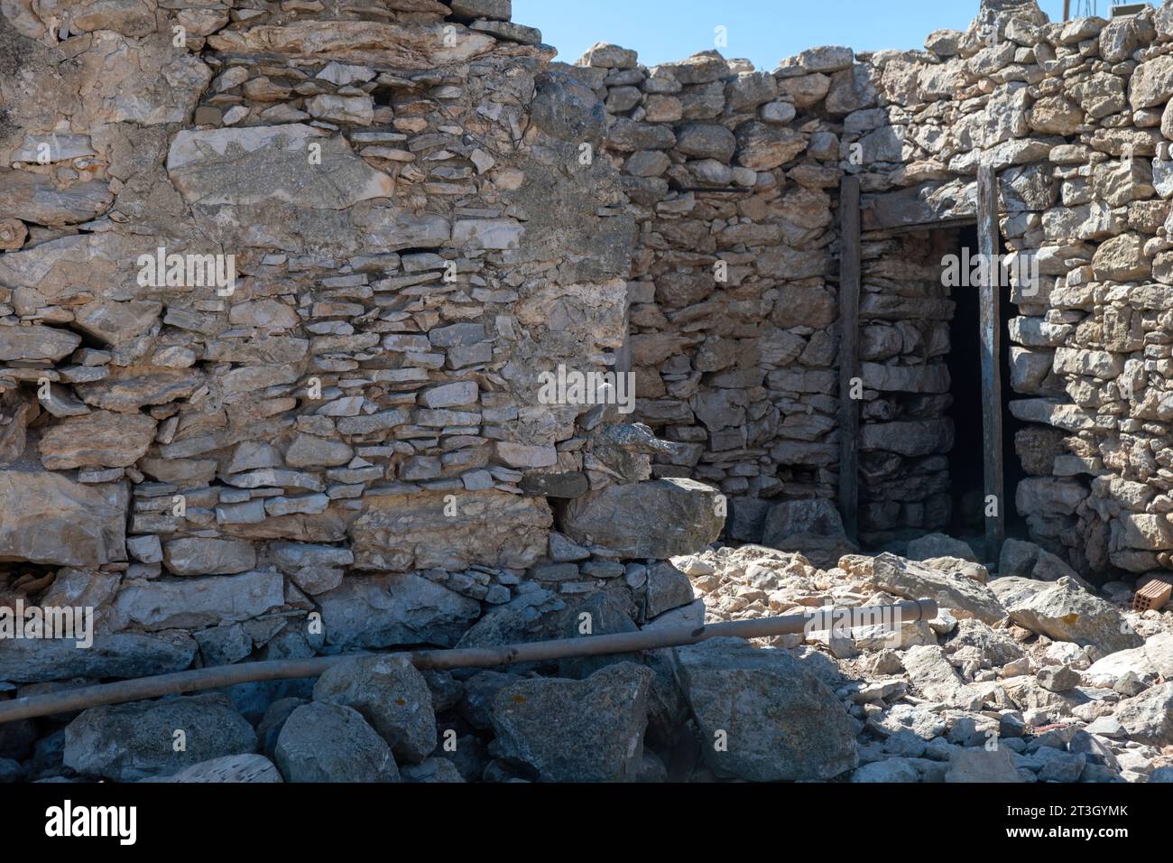 Abandoned stonewall building with wooden plank as door frame at Gavdos