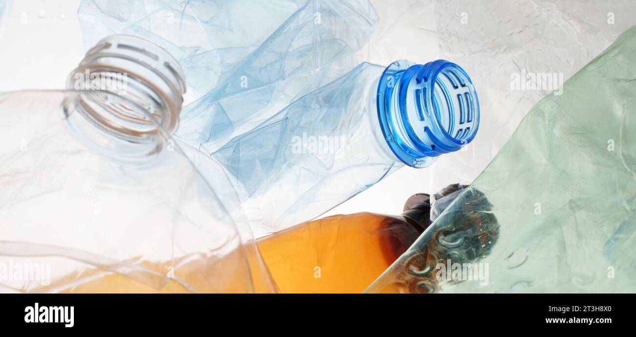 Many transparent bottles color plastic PET recycling waste. Empty plastic bottles background. Pile of empty bottle recycling plastic material Stock Photo