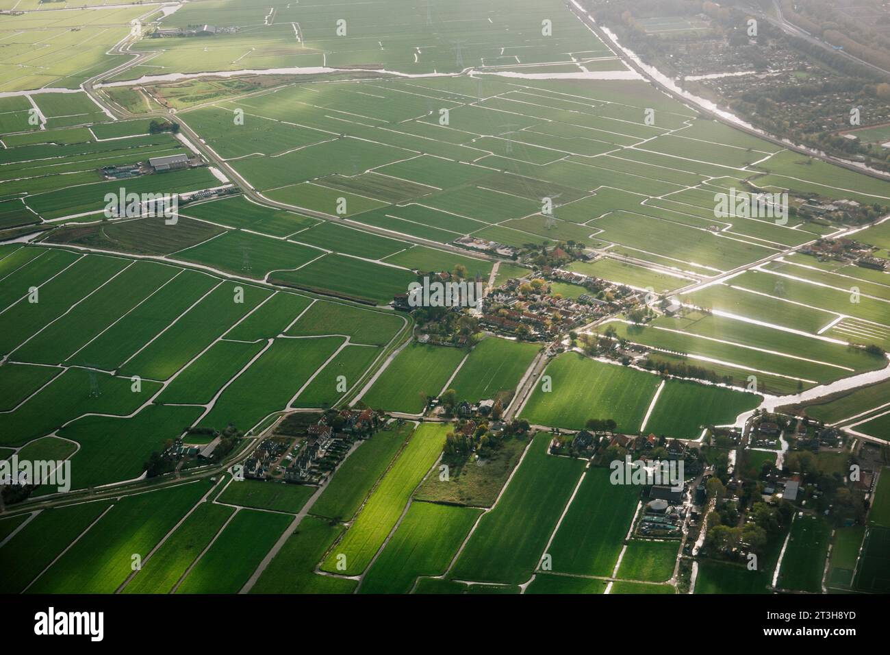 Small villages and farmland criss-crossed by canals, on the outskirts of Amsterdam, Netherlands Stock Photo