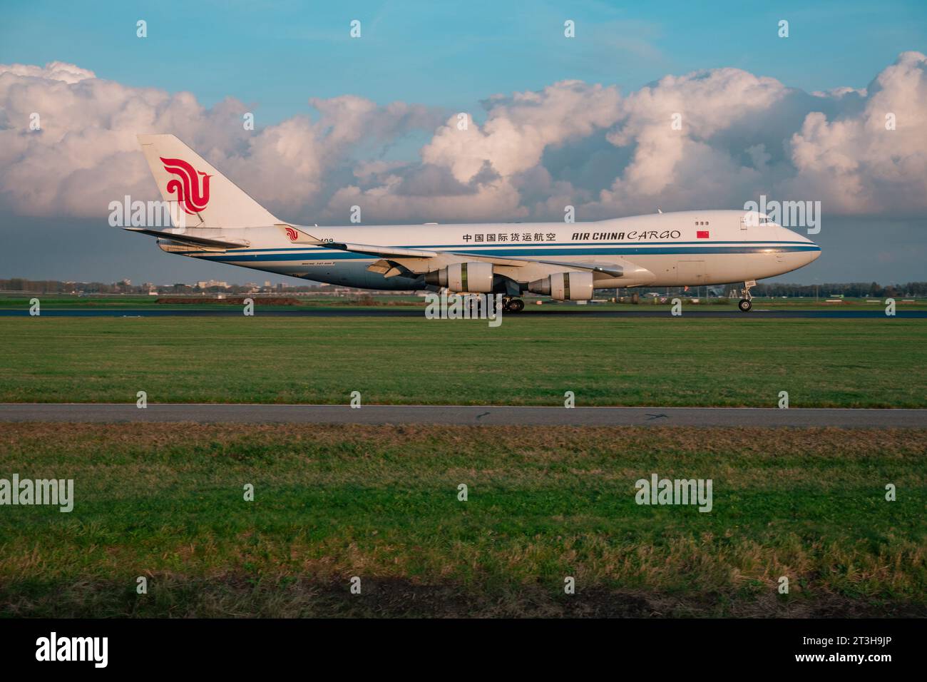 an Air China Cargo Boeing 747 cargo plane lands at Amsterdam Schiphol airport in evening light Stock Photo