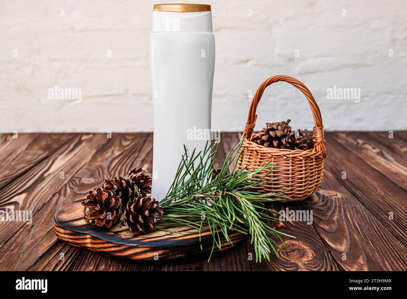 Natural shampoo made from herbs and cones. Dispenser on a wooden board ...