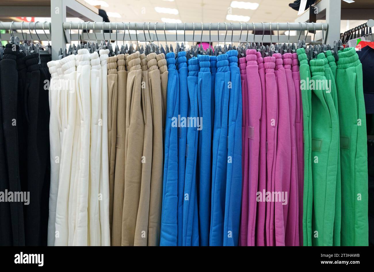 Premium Photo  A row of hangers with cheap pants in the store in