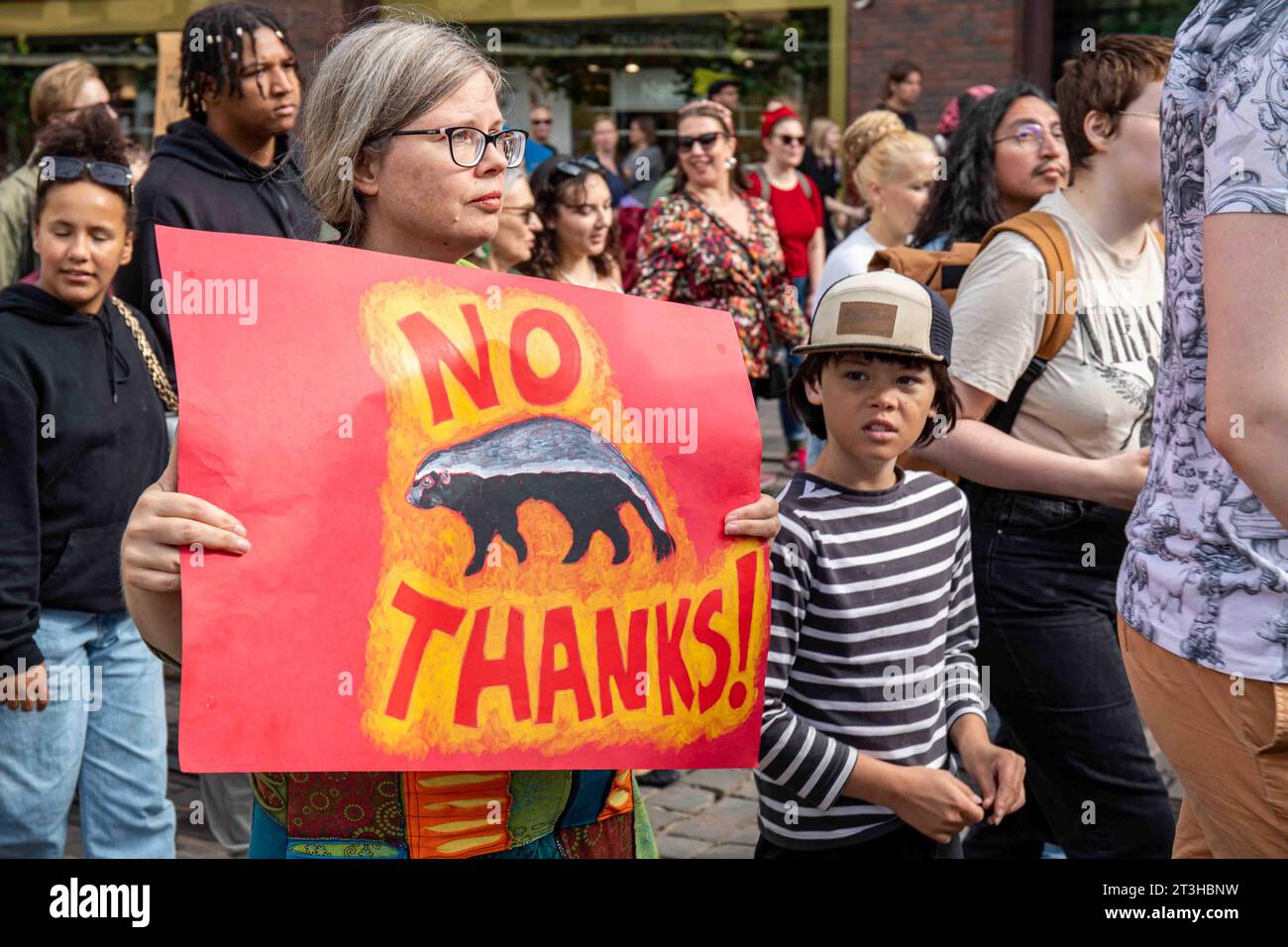 No Thanks! Protester holding a sign with a picture of honey badger at Me emme vaikene! anti-racism demonstration in Helsinki, Finland. Stock Photo